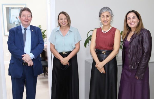 Fotografia de quatro pessoas perfiladas, lado a lado, sendo um homem e tr&ecirc;s mulheres